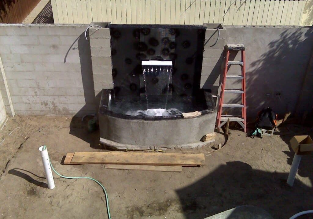 Fountain Construction with sheer descent waterfall after polyurea spray on liner waterproofing, ready to be completed